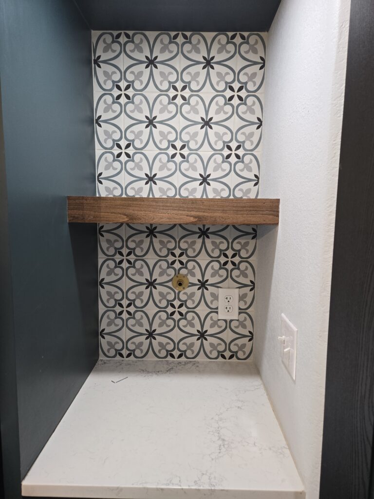 Decorative shower niche tile installation with patterned tile