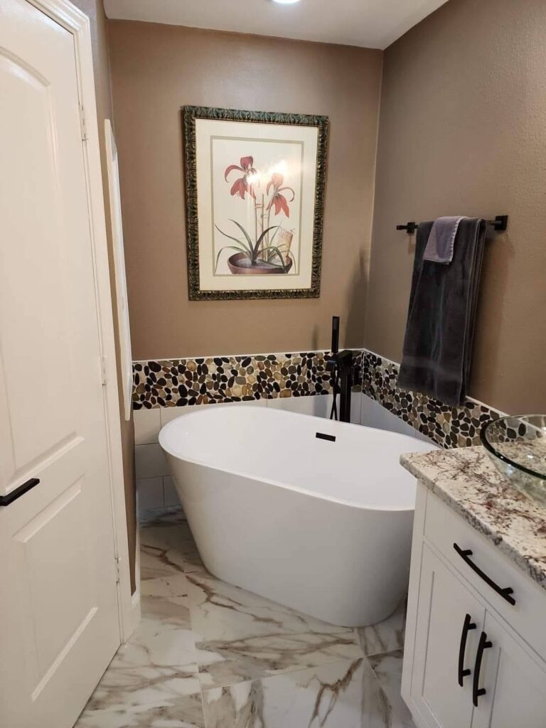 Freestanding bathtub with custom bathroom tile installation by JPond Custom Tile