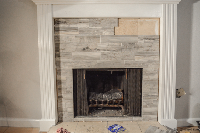 Rustic stone fireplace tile surround installation