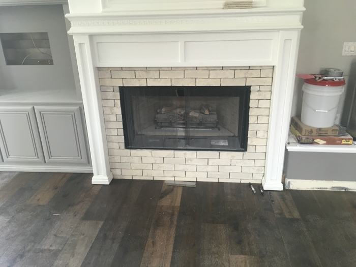 White tile fireplace surround installation