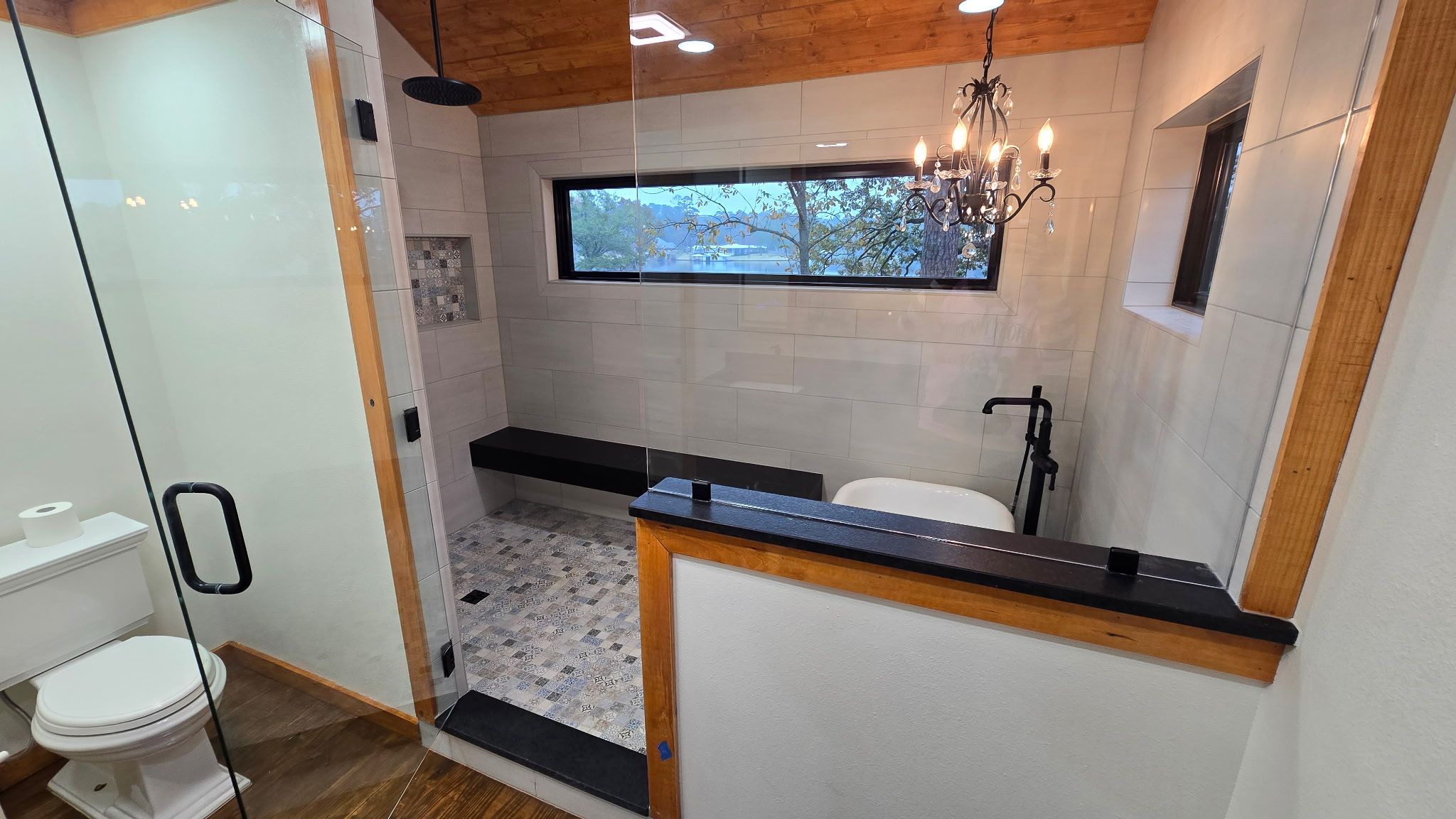 Custom walk-in shower tile installation with glass enclosure by JPond Custom Tile
