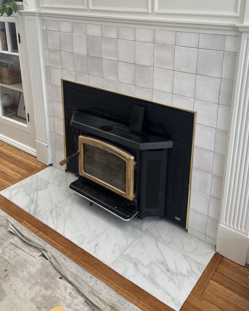 Fireplace tile surround with wood stove installation by JPond Custom Tile