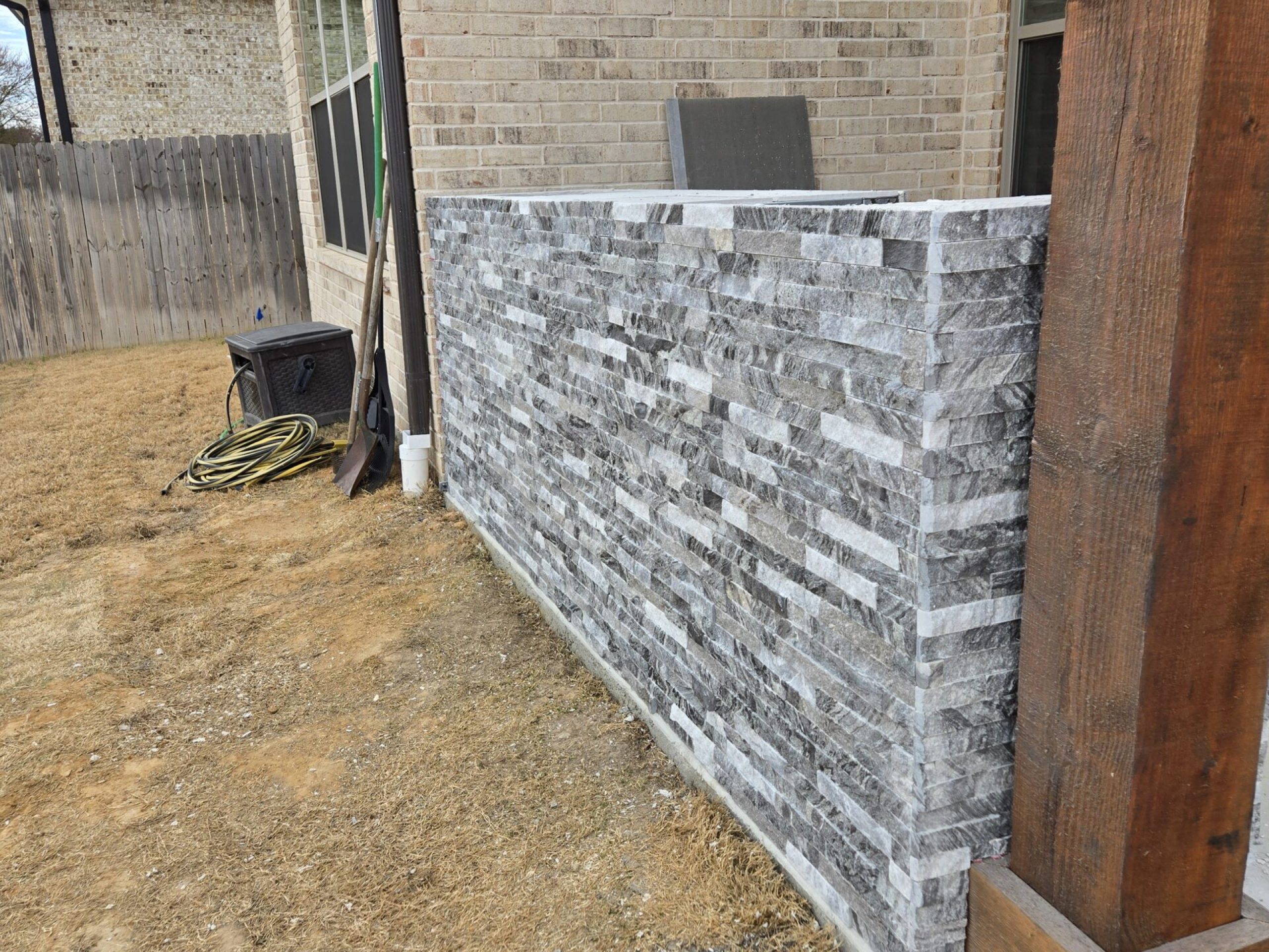 Exterior stone tile wall and column installation by JPond Custom Tile Tyler TX