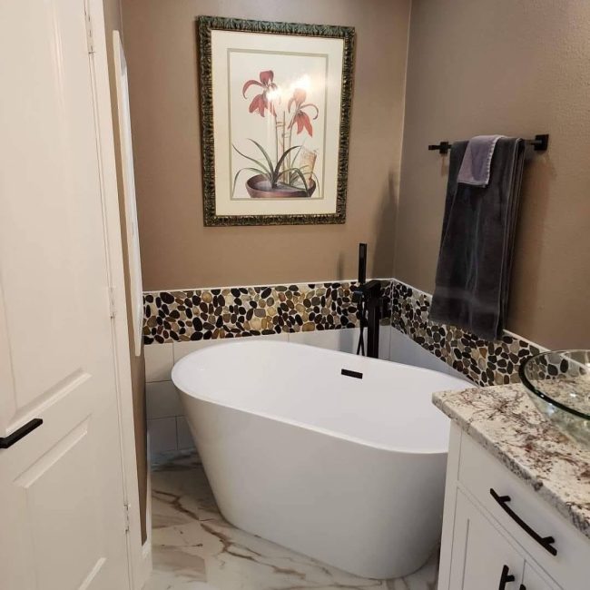 Freestanding bathtub with custom bathroom tile installation by JPond Custom Tile