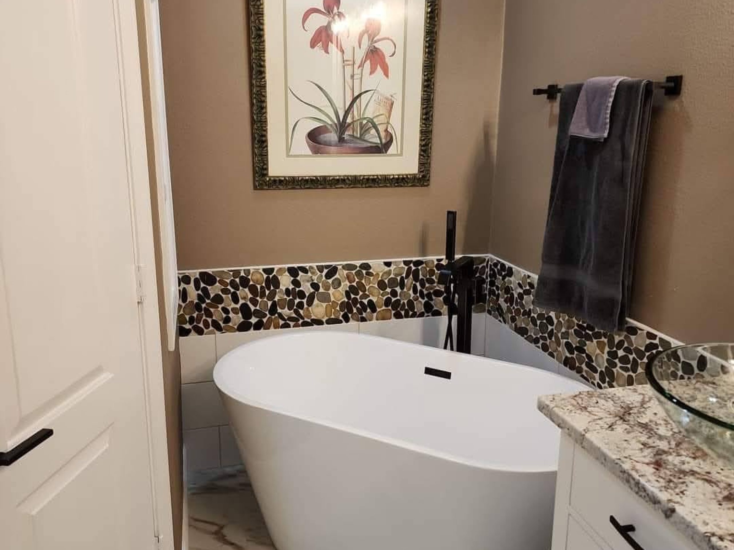 Freestanding bathtub with custom bathroom tile installation by JPond Custom Tile