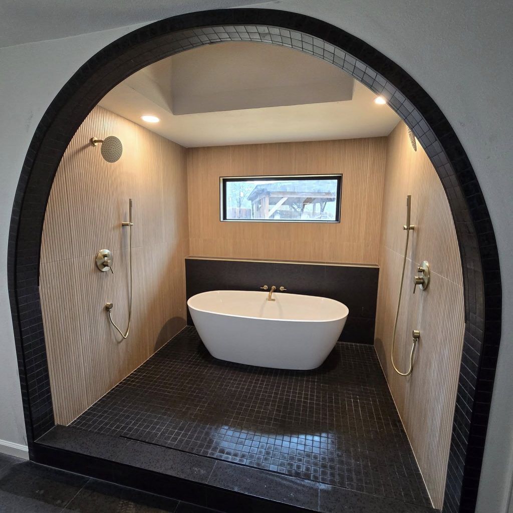 Luxury bathroom tile installation with freestanding tub and walk-in shower